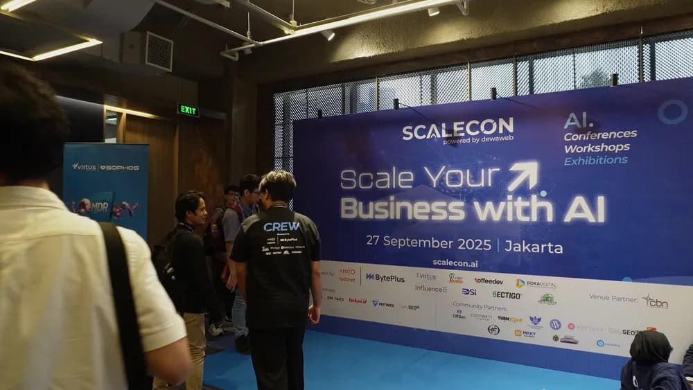 Attendees beside the SCALECON Jakarta 2025 backdrop in the venue foyer