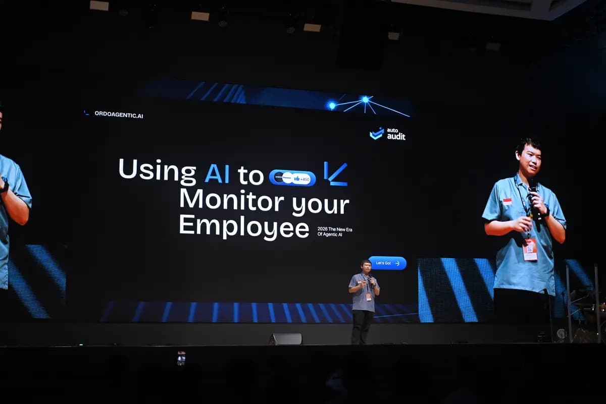 A speaker on the main stage during a session on AI monitoring at SCALECON Surabaya 2026