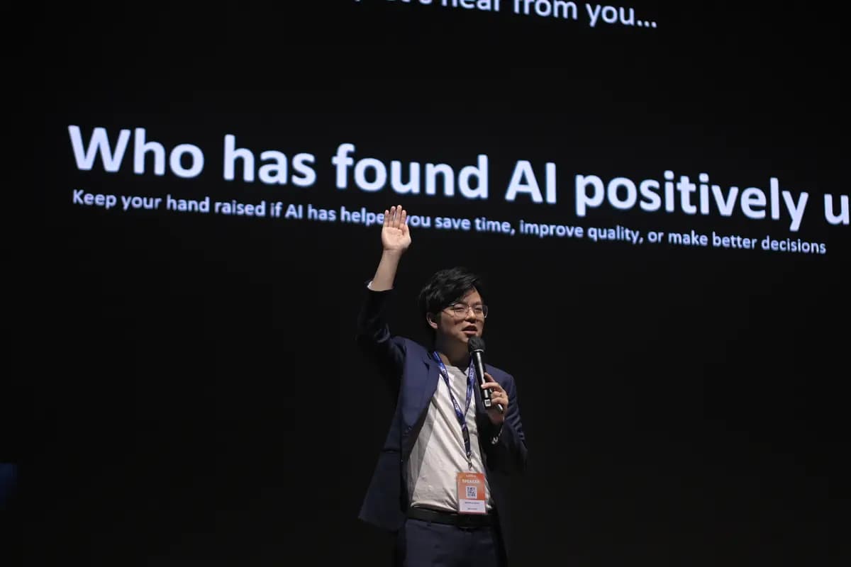 A speaker asking the room to keep a hand up if AI has genuinely saved them time, at SCALECON Surabaya 2026