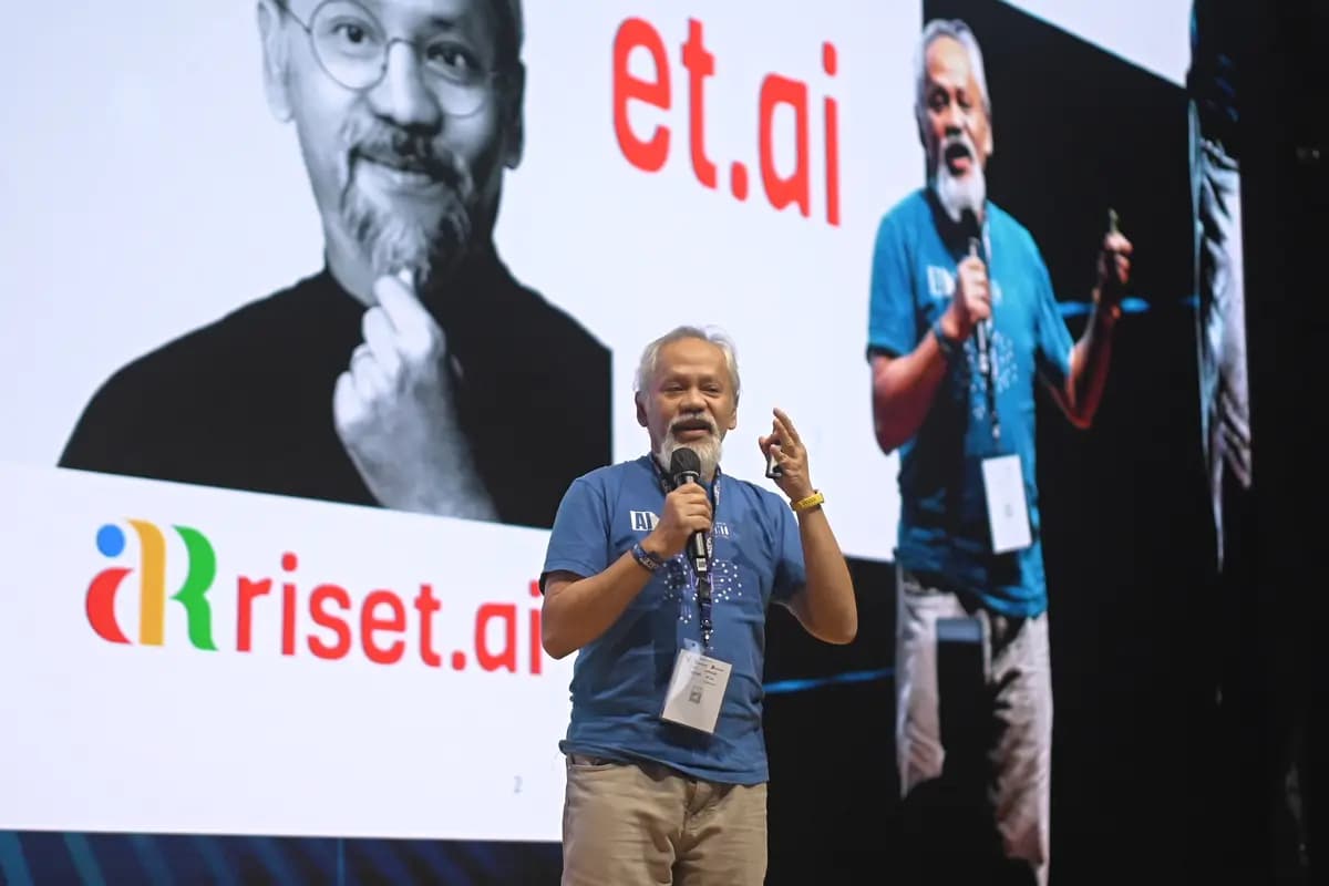A researcher presenting with a microphone at SCALECON Surabaya 2026