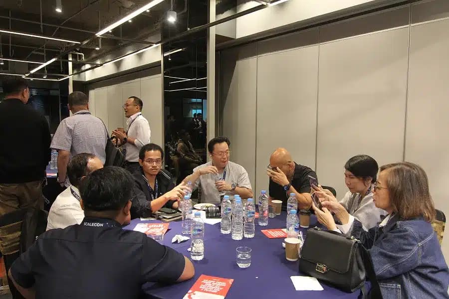 A table mid-conversation over lunch at a previous SCALECON