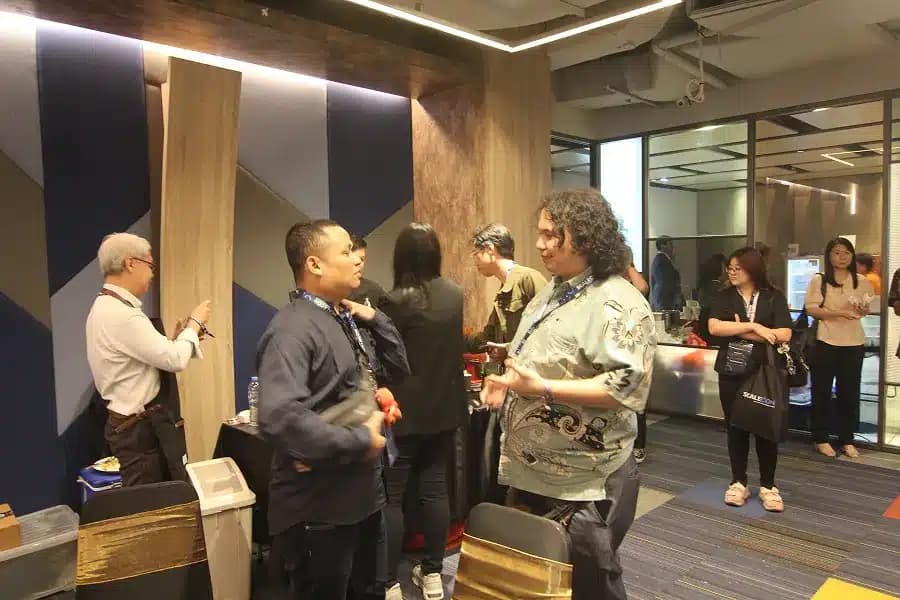 Attendees standing and talking near the venue entrance at a previous SCALECON
